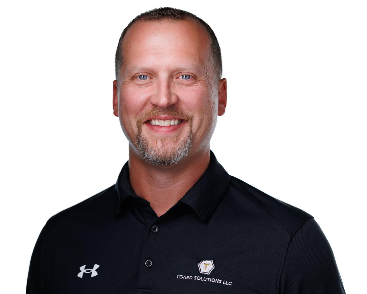 Owner of Tgard Solutions in a black polo shirt.